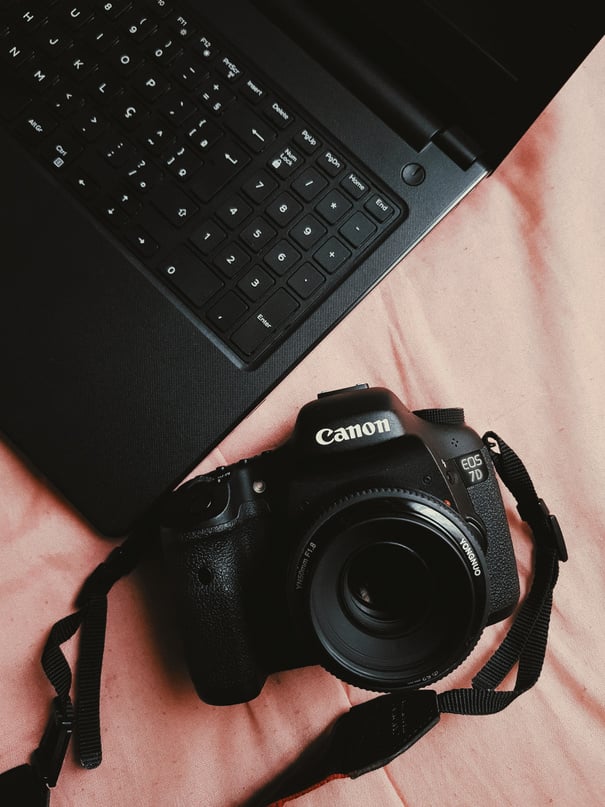 Black Canon Dslr Camera Near Black Laptop Computer